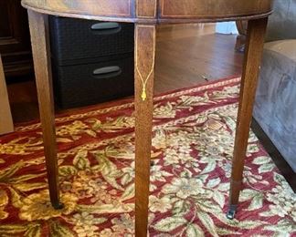 Vintage Weiman Heirloom Side Table
Table is wood , Brown leather top with Gold tooling ,  four inlaid legs ending on casters. 23"x 28"                                  $25.00
