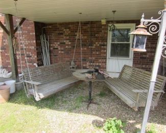 two wooden porch swings