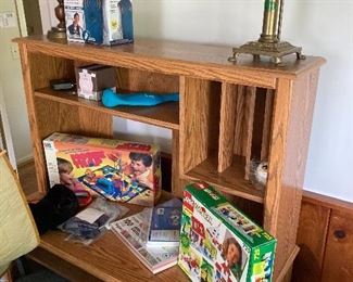 More assorted games displayed on second wooden desk with chair