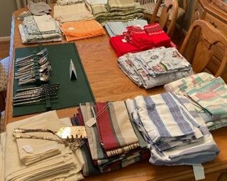 Large assortment of linens and full set of international flatware