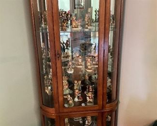 Loaded curio  cabinet filled with Hummels