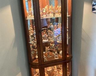 Loaded curio cabinet filled with Hummels