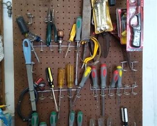 Peg board W/ screwdrivers, metal files, needle nose pliers, wrenches, & pipe cutter