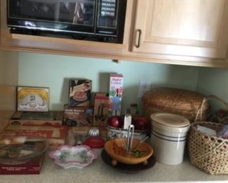 Vintage Baking Utensils, Birch Basket of Faux Apples, Nut Dish, Blueband Gallon Crock, Large Basket of Loose Recipes, Open Weave Basket with Miscellaneous items (birthday banner, birthday candles, confetti).