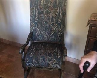 One of two Elizabethan revival open arm chairs with paisley upholstery.