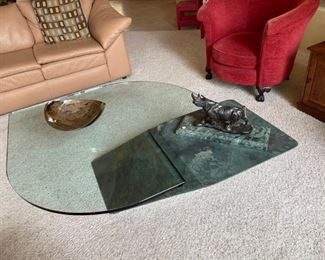 Ok. This is art. The glass on this coffee table is one inch thick and heavy! The pedestal base is cantilevered to make for the perfect balance. The rhino bronz e makes it complete. Forget the bowl.
