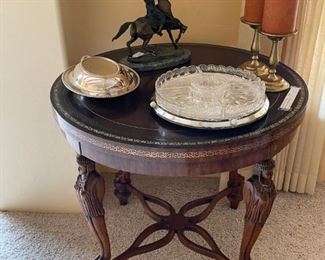 Wonderful round walnut accent table with a leather top and four female caryatid legs with double cross stretcher. We do not see these very often.