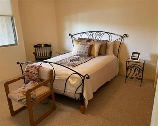 Wonderful wrought iron Queen bed with mattress and box springs. Very comfy. Also has glass topped side table.