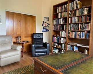 Books! Plus comfy reading chairs. And the edge of a cool area rug and a partner's desk. So convenient for the working at home mindset.
