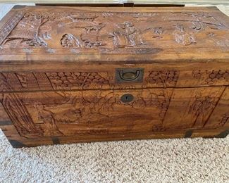 Camphor chest has detailed carvings.