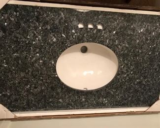 37" Gray Granite Vanity Sink Top.  Pre-drilled for centerset faucet with 3-hole installation.  Matching backsplash included.  37W x 22D x 3/4H.  New in box.