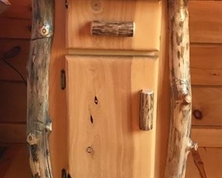 One of two juniper log bedside tables