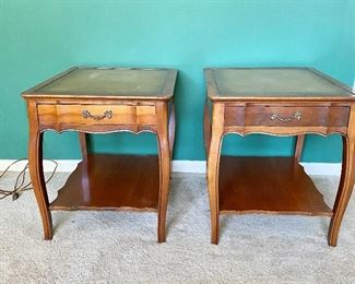 Pair of nice wooden tables with leather tops.