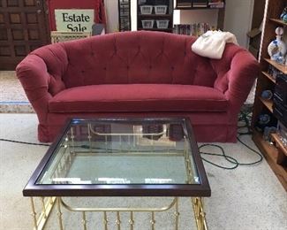 Awesome beveled glass coffee table.  Tufted velvet sofa. 