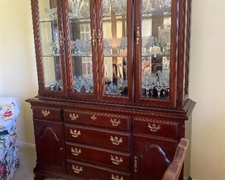 Gorgeous cherry china cabinet, lighted with beveled glass.