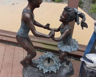 Bronze sculpture of girls playing in a fountain