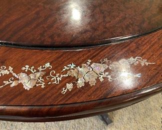 ITEM 7: Mother of pearl inlay table, oval, measurement is smallest size. comes with two arm chairs and six side chairs. Chairs have solid wood seats, come with brocade custom seat cushions and feature mother of pearl inlay on both sides of center back. Two leaves 17.825” wide, as shown - 59” 3/8 x 30” tall, 44” $1,350