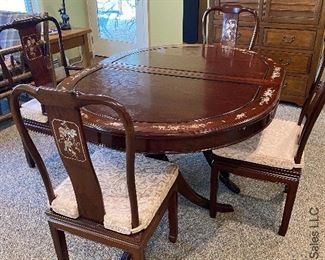 ITEM 7: Mother of pearl inlay table, oval, measurement is smallest size. comes with two arm chairs and six side chairs. Chairs have solid wood seats, come with brocade custom seat cushions and feature mother of pearl inlay on both sides of center back. Two leaves 17.825” wide, as shown - 59” 3/8 x 30” tall, 44” $1,350
