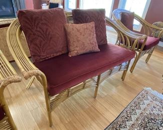 ITEM 12: Rattan three piece seating set. Loveseat and two arm chairs. 55” wide, 33” deep, 33” tall chair is 32” wide. $575
