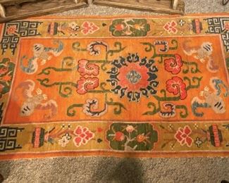 ITEM 35: Tibetan wool rug, orange, with bats. ~3'x5' $325