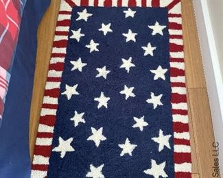 ITEM 58: Hooked synthetic rug. Red,white & blue w/ stars. 21” x 31" $35