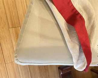 ITEM 139: Set of 8 Pottery Barn parsons chairs. Upholstered in khaki, slipcovered in beige linen with red trim. Some minor wear damage consistent with age $600