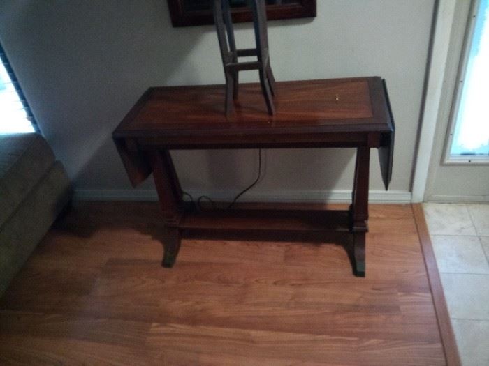 antique entry table both end drop down. It is about 15" wide, 36" long and 25" tall price is $75. It is a Mahogany table from the 1940's
