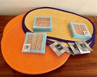 Item 253:  (5) Raffia Placemats with Purple Trim, (15) Orange Raffia Placemats, and (3) Sets of Coasters:  $28