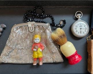 Antique chainmail purse, small football boy figurine, shaving brush, pocket watch