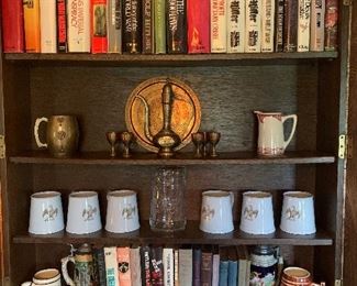 Family Room 
Copeland eagle mugs, steins, books, Syracuse Santa Fe pitcher, brassware