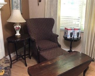 Assorted living room furniture. Coffee table, wing back chair with ottoman. Assorted lamps and side tables.