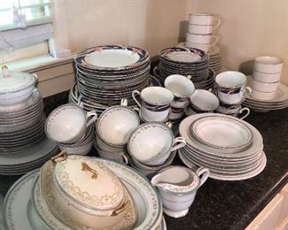 Multiple sets of good china and dishes. 