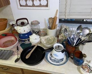 Cast iron pans, stoneware pitchers, and other kitchen item. 