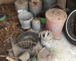 Antique and vintage gas cans, watering cans, wire basket 