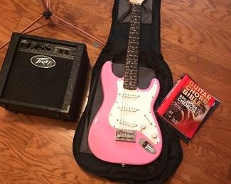 Ladies or teens pink electric guitar and amplifier and pink music stand