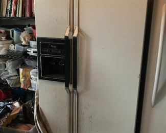 Older refrigerator with ice and water dispenser in the door 
