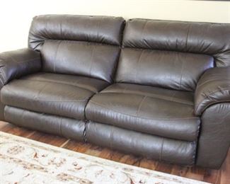 #28.  $250.00   Chocolate brown leather reclining sofa each side reclines 40” X 85” X 38” 