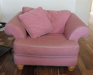 #43.  $100.00   Pink over sized chair wear to fabric / fading 32” X 51” X 33” 