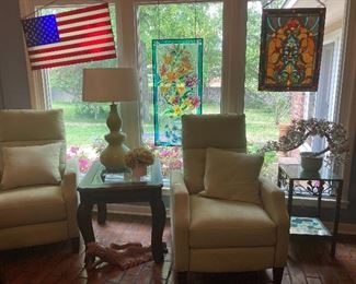 Matching green microfiber recliners, stained glass and jade cherry blossom sculpture.