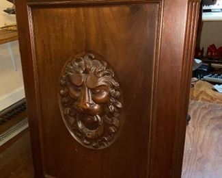Solid wood door panel with lion motif.