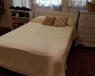 Full size bed with chenille bedspread.