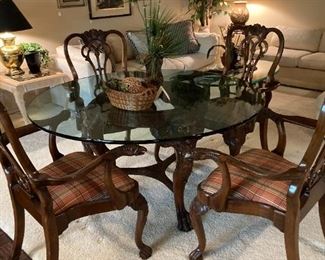 This lovely glass top dining table has  4 chairs.