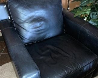 One of two "sooooooooo comfortable" black leather club chairs