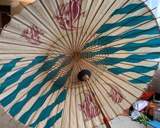 Giant vintage paper umbrella with blue stripes and angel fish