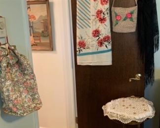 Vintage roller skates, one of several gorgeous tablecloths, straw purse