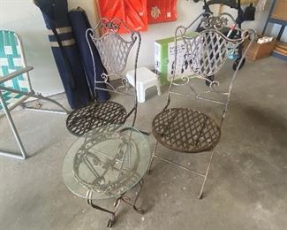 Pair of metal chairs and glass-top table