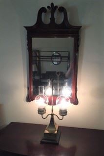 Note the lamp.  Two light sources; the mirror appears to double the bulbs.  