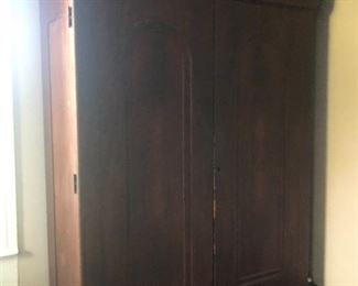 Flame Mahogany Empire Armoire with arched top panels.  $1600