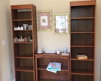 Two narrow bookcases and short book case