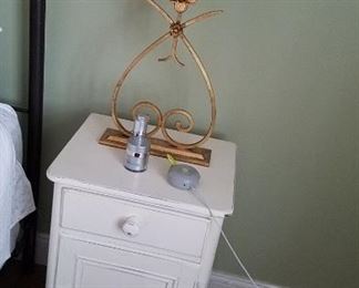 white painted bedside cabinet, brass tone decorative lamp